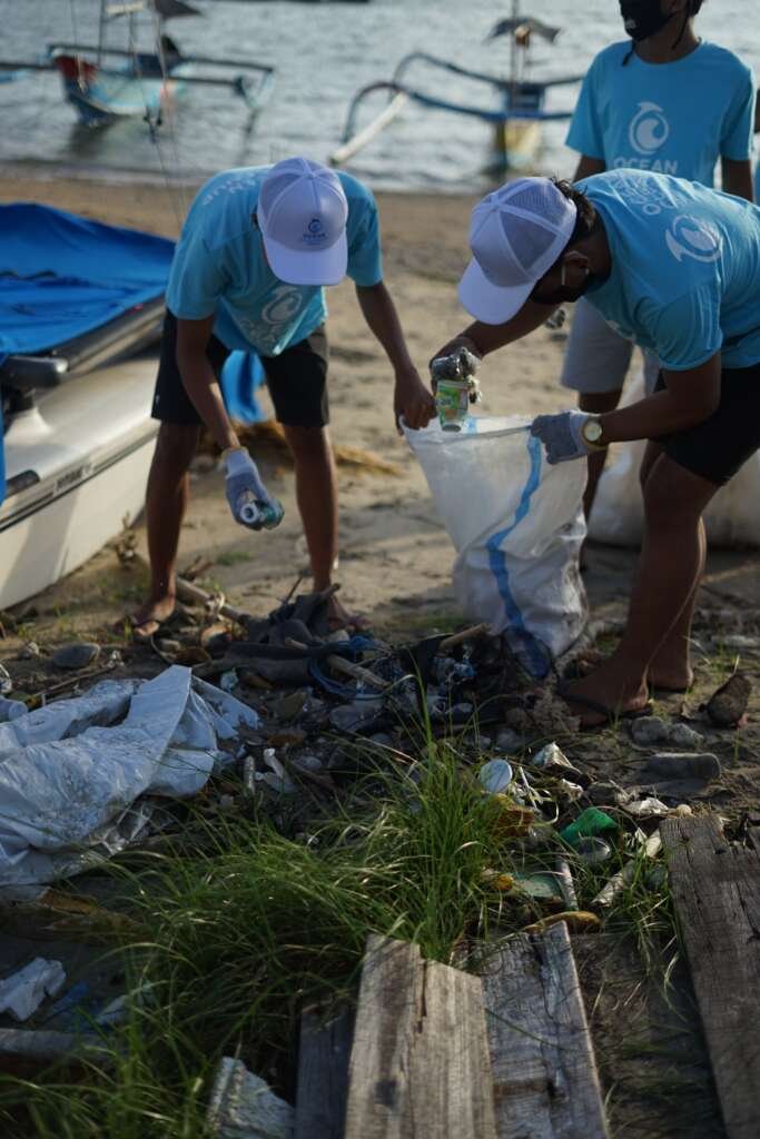A cleanup crew from the organization Saving the Ocean plastic trash from a beach